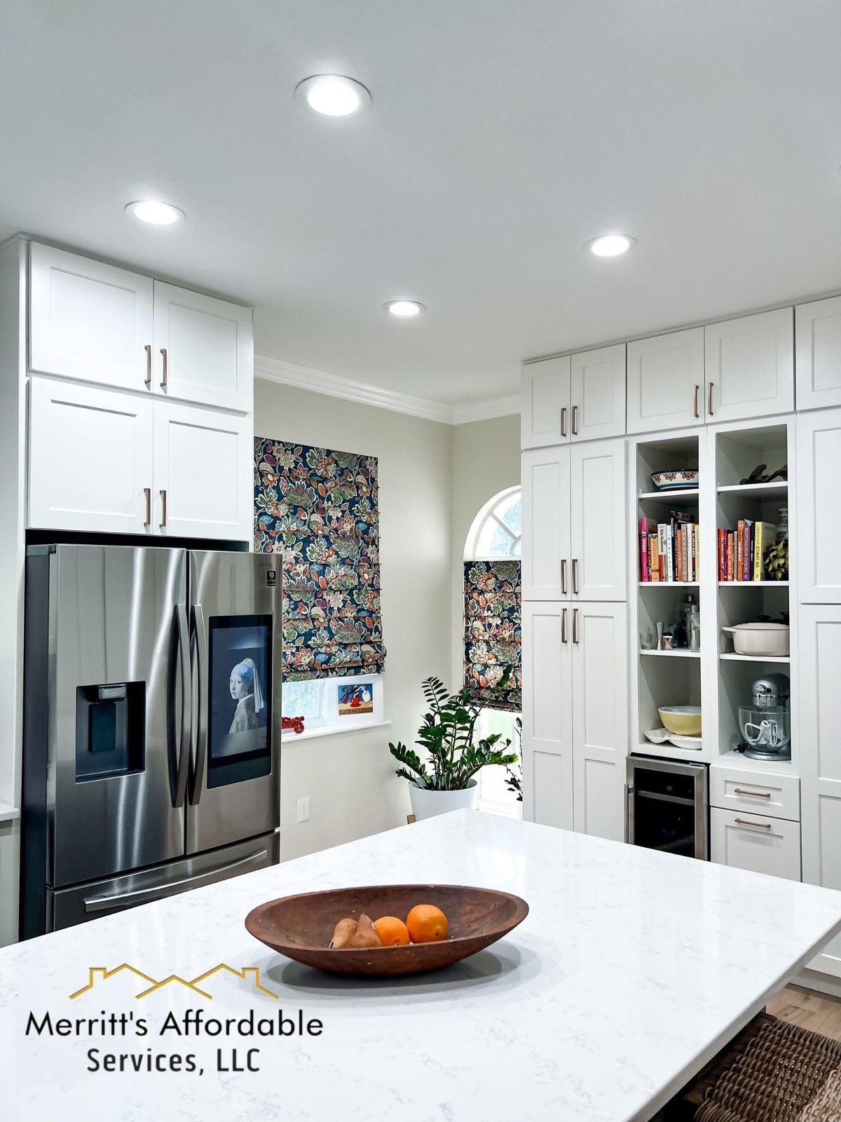 Full kitchen remodel in Winter Haven, FL with arched window detail and quartz island
